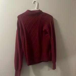 Maroon sweater with buttons on one side of the shoulder